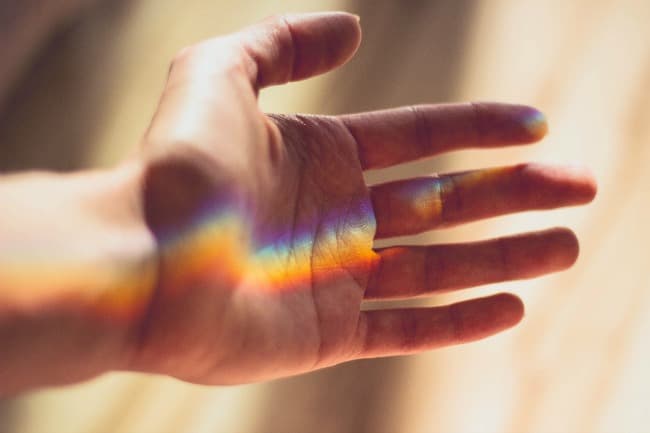 Rainbow reflected on human hand